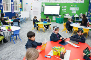 Students using technology in modern classroom at St Michael's Catholic Primary School Daceyville