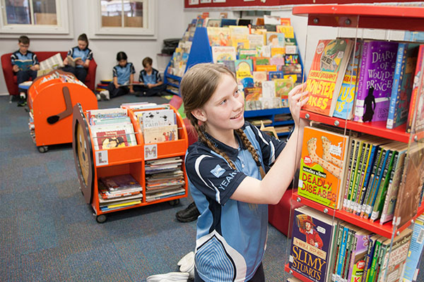 Students reading books at St Michael's Catholic Primary School Daceyville library