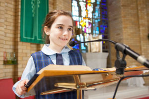 St Michael's Catholic Primary School Daceyville student reading at lecturn in church